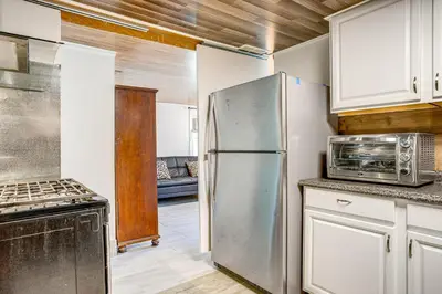 a kitchen with a refrigerator and a microwave at Aurora Abode 7 Mi to Dtwn Denver! in Aurora