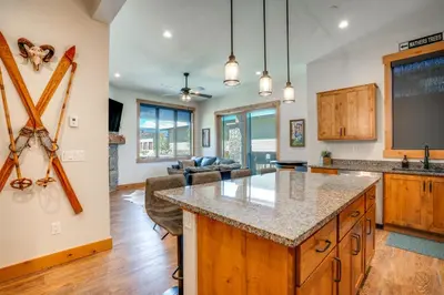 a kitchen and living room with a large island at Modern Elk Creek Condo with Hot Tub and Heated Floors in Fraser