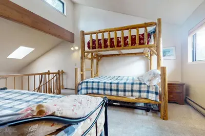 a bedroom with two bunk beds in a attic at Viking Alpine Haven in Winter Park