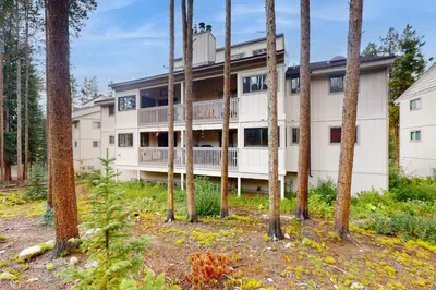 an apartment building with trees in the foreground at Viking Alpine Haven in Winter Park