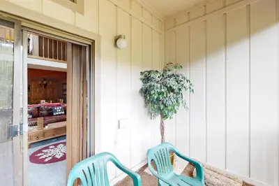 two blue chairs sitting on a porch with a tree at Viking Alpine Haven in Winter Park
