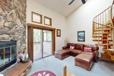 a living room with a couch and a fireplace at Viking Alpine Haven in Winter Park