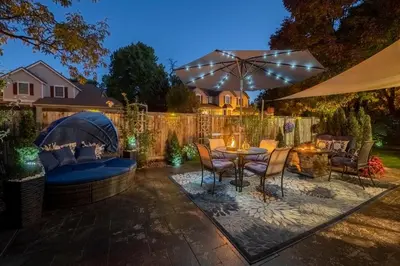 a patio with a table and chairs and an umbrella at Immersive Spa Retreat with Sauna & 15m to Red Rocks in Lakewood