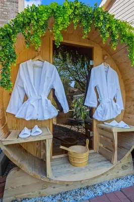 a wooden house with a robe and shoes on display at Immersive Spa Retreat with Sauna & 15m to Red Rocks in Lakewood