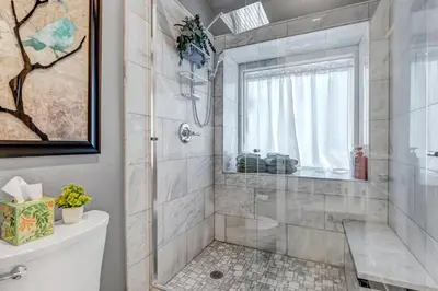 a bathroom with a shower and a toilet at Immersive Spa Retreat with Sauna & 15m to Red Rocks in Lakewood