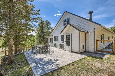 a house with a patio with tables and chairs at Golden Gate Getaway home in Black Hawk