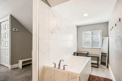 a white bathroom with a tub and a sink at Golden Gate Getaway home in Black Hawk
