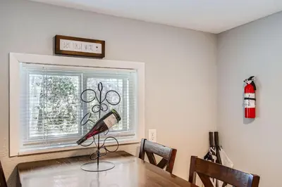 a room with a table and a window with a fire extinguisher at Golden Gate Getaway home in Black Hawk