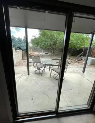 a window view of a patio with a table and chairs at Executive Ranch near Old Town in Fort Collins