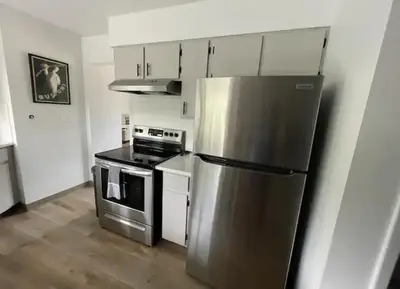 a kitchen with a stainless steel refrigerator and a stove at Executive Ranch near Old Town in Fort Collins