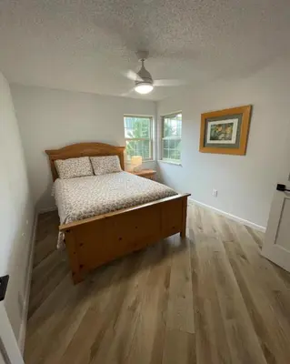 a bedroom with a wooden bed in a room at Executive Ranch near Old Town in Fort Collins