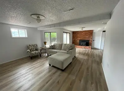 a living room with a couch and a chair at Executive Ranch near Old Town in Fort Collins