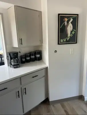 a kitchen with white cabinets and a white refrigerator at Executive Ranch near Old Town in Fort Collins