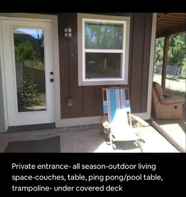 a screened in porch with a door and a chair at River Mountain Getaway-private, large, in- law apt in Jamestown