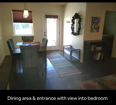 a living room with a dining area and entrance with view into bedroom at River Mountain Getaway-private, large, in- law apt in Jamestown