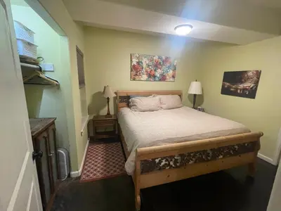 a small bedroom with a bed and two lamps at River Mountain Getaway-private, large, in- law apt in Jamestown
