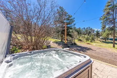 a hot tub in the backyard of a house at Near Red Rocks with Hot Tub, Fire Pit and Views in Indian Hills