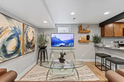 a living room with a table and a tv on a wall at Whole House Relaxing Oasis by Fitzsimmons Campus in Aurora