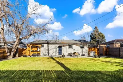 a house with a grassy yard in front of it at Whole House Relaxing Oasis by Fitzsimmons Campus in Aurora