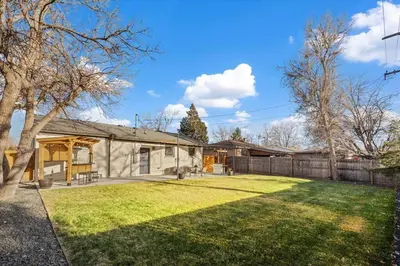 a house with a fence and a yard at Whole House Relaxing Oasis by Fitzsimmons Campus in Aurora