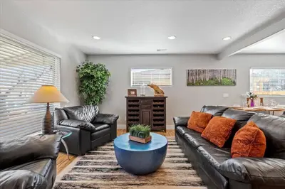 a living room with leather couches and a table at Whole House Relaxing Oasis by Fitzsimmons Campus in Aurora