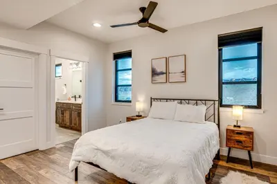 a bedroom with a bed and a ceiling fan at Private Hot Tub and Patio Granby Mtn Retreat! in Granby