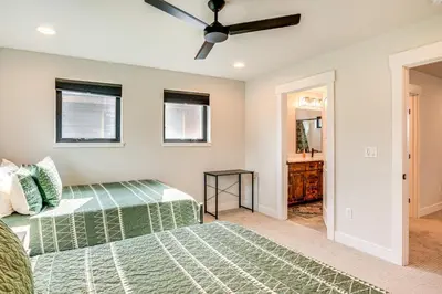 a bedroom with a bed and a ceiling fan at Private Hot Tub and Patio Granby Mtn Retreat! in Granby