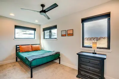a bedroom with a bed and a window at Private Hot Tub and Patio Granby Mtn Retreat! in Granby