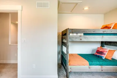 a bedroom with bunk beds in a house at Private Hot Tub and Patio Granby Mtn Retreat! in Granby