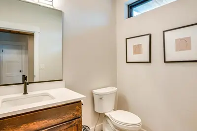 a bathroom with a toilet and a sink and a mirror at Private Hot Tub and Patio Granby Mtn Retreat! in Granby