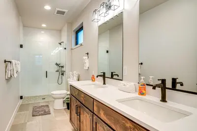 a bathroom with a sink and a toilet and a mirror at Private Hot Tub and Patio Granby Mtn Retreat! in Granby