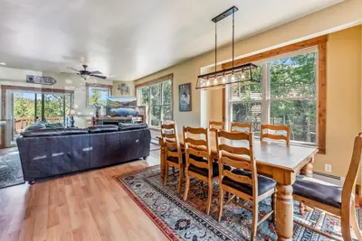 a dining room with a table and chairs and a couch at Mountain Escape with Hot Tub Near Ski Resorts and I 70 in Silverthorne