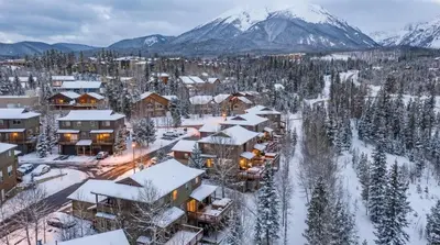 a town covered in snow with mountains in the background at Mountain Escape with Hot Tub Near Ski Resorts and I 70 in Silverthorne