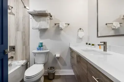 a white bathroom with a toilet and a sink at 1824 The Seasons townhouse in Keystone