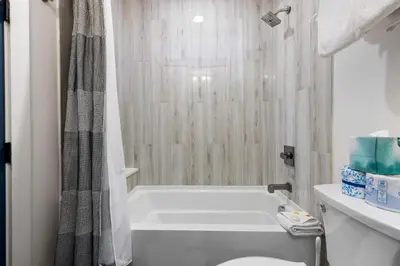 a bathroom with a tub and a toilet and a shower at 1824 The Seasons townhouse in Keystone