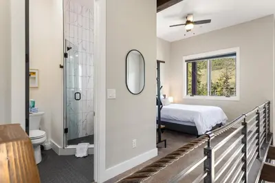 a bedroom with a bed and a shower and a toilet at 1824 The Seasons townhouse in Keystone