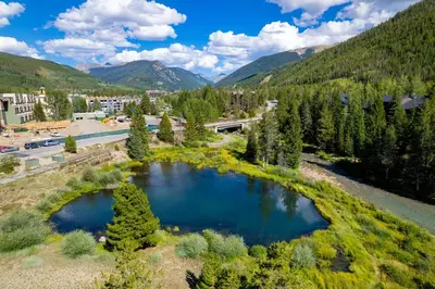 an aerial view of a river with a town and mountains at 1824 The Seasons townhouse in Keystone