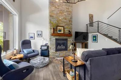 a living room with a couch and a fireplace at 1824 The Seasons townhouse in Keystone