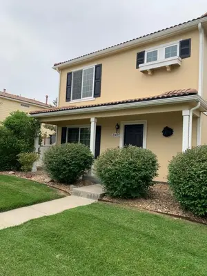 a house with bushes in front of it at Charming 3 bed 3 bath home, super cozy, close to DIA in Altura