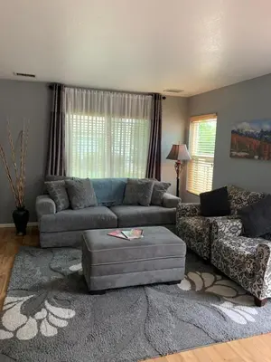 a living room with a couch and a chair at Charming 3 bed 3 bath home, super cozy, close to DIA in Altura