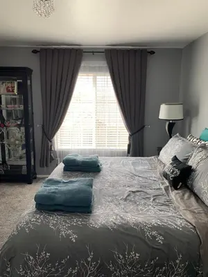 a bedroom with a bed with two pillows on it at Charming 3 bed 3 bath home, super cozy, close to DIA in Altura