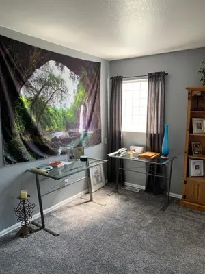 a room with a desk and a painting on the wall at Charming 3 bed 3 bath home, super cozy, close to DIA in Altura