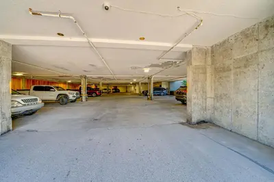 an empty parking garage with cars parked in it at Ski Retreat with Hot Tub Access in Winter Park! in Winter Park