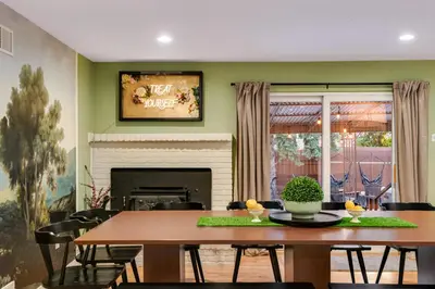 a dining room with a table and a fireplace at Mid Summer Night's Dream w Hot Tub Theater Game Room in Arvada