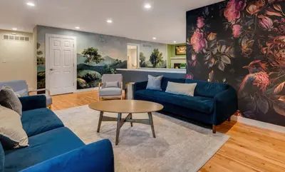 a living room with blue couches and a table at Mid Summer Night's Dream w Hot Tub Theater Game Room in Arvada