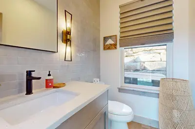 a bathroom with a sink and a toilet and a window at Rendezvous Retreat in Fraser