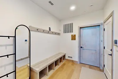 a room with a bench and a blue door at Rendezvous Retreat in Fraser