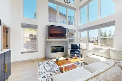 a living room with a couch and a fireplace at Rendezvous Retreat in Fraser