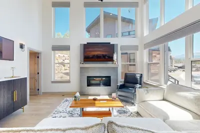 a living room with a couch and a fireplace at Rendezvous Retreat in Fraser