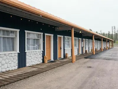 a green building with a row of windows on it at LOGE Breckenridge in Gold Hill